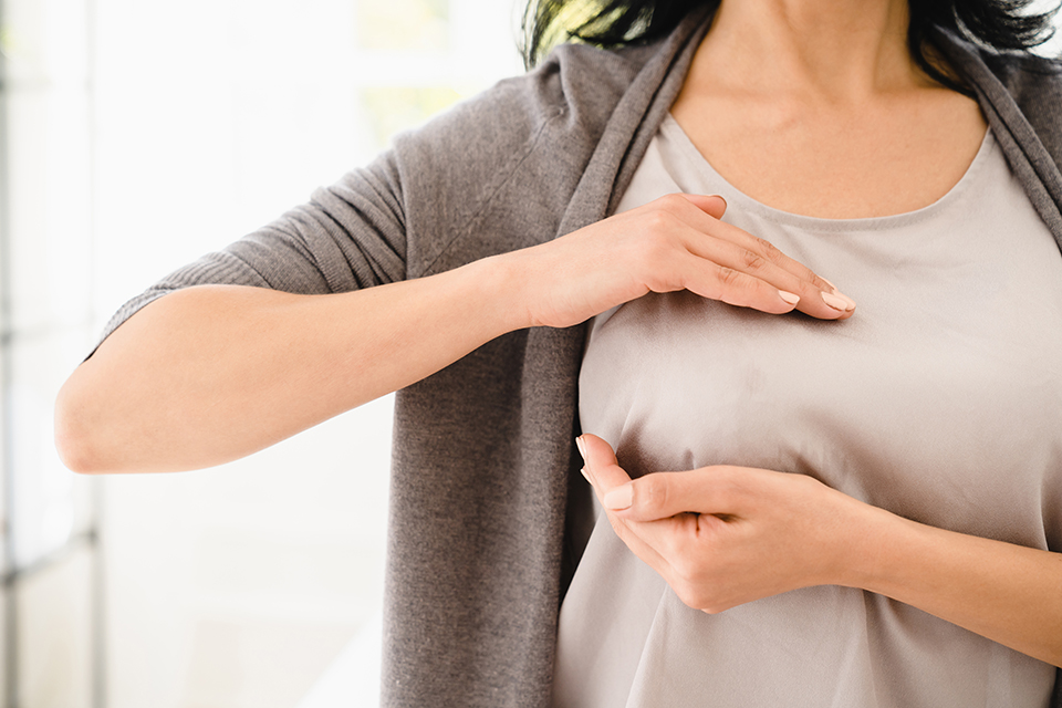 Palpation of her breast for prevention breast cancer. Self-checking medicine. World cancer day Caucasian woman doing palpation of her breast for prevention breast cancer. Self-checking medicine for female. World cancer day
