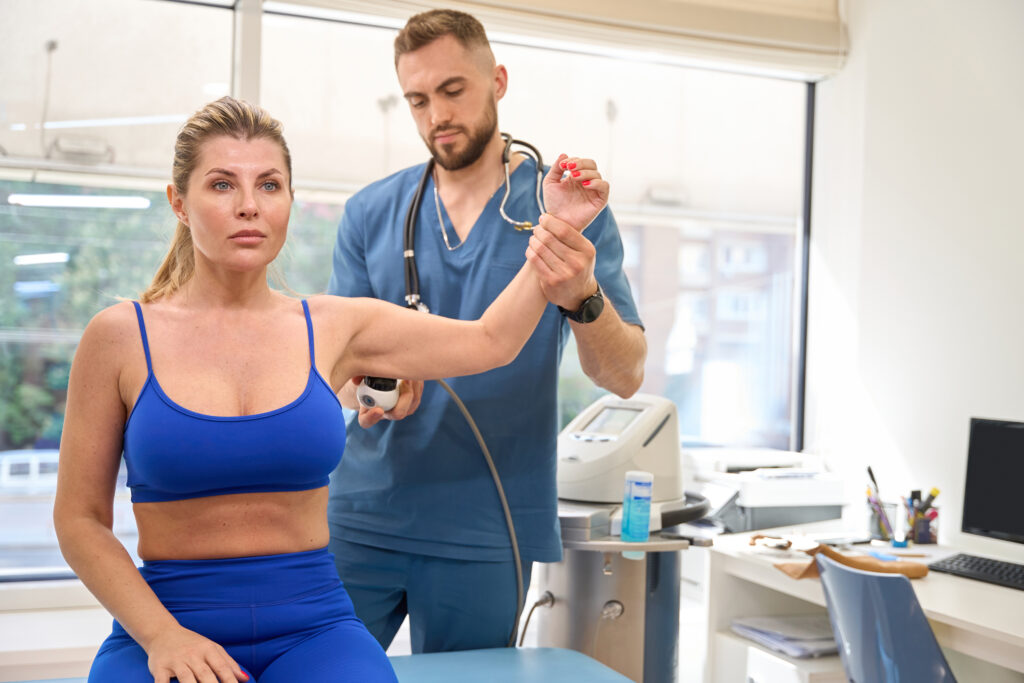 physiotherapist performing extracorporeal shock